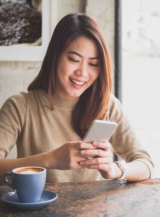 Woman sending SMS on mobile phone