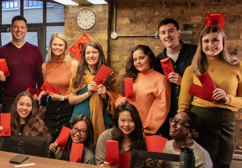 Chinese New Year - Group of staff holding red envelopes